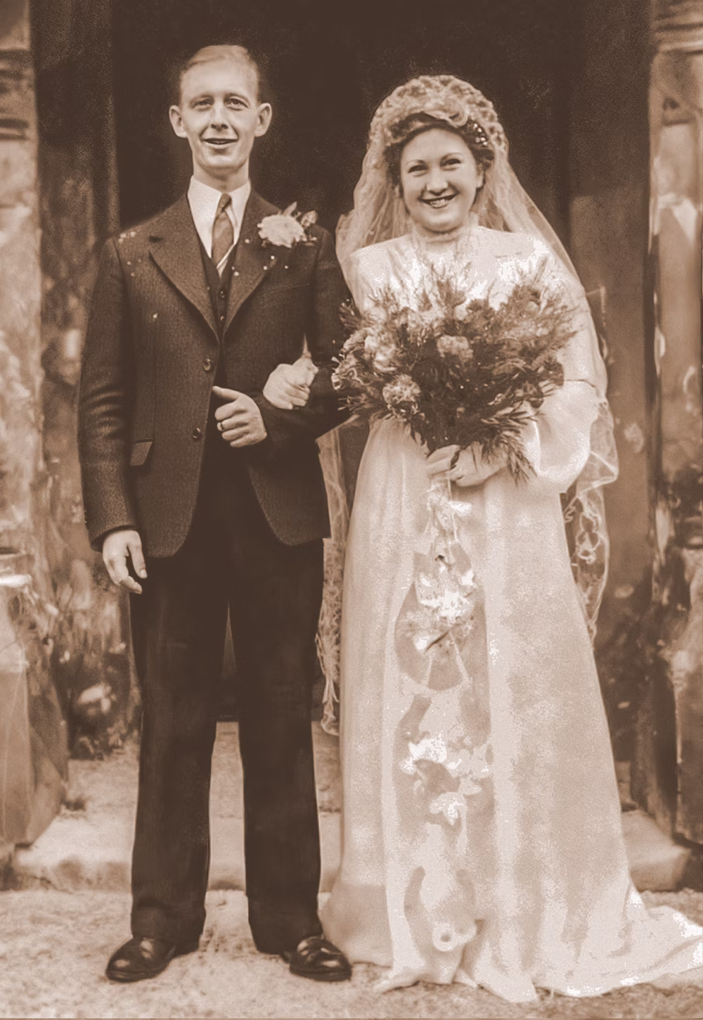 Black and white vintage wedding photograph of a bride and groom, before colourisation