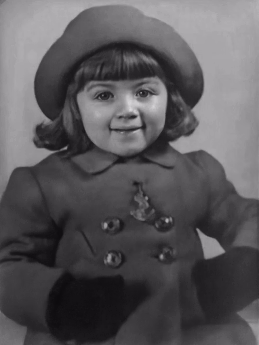 Black and white 1962 studio portrait of a young girl, before colourisation