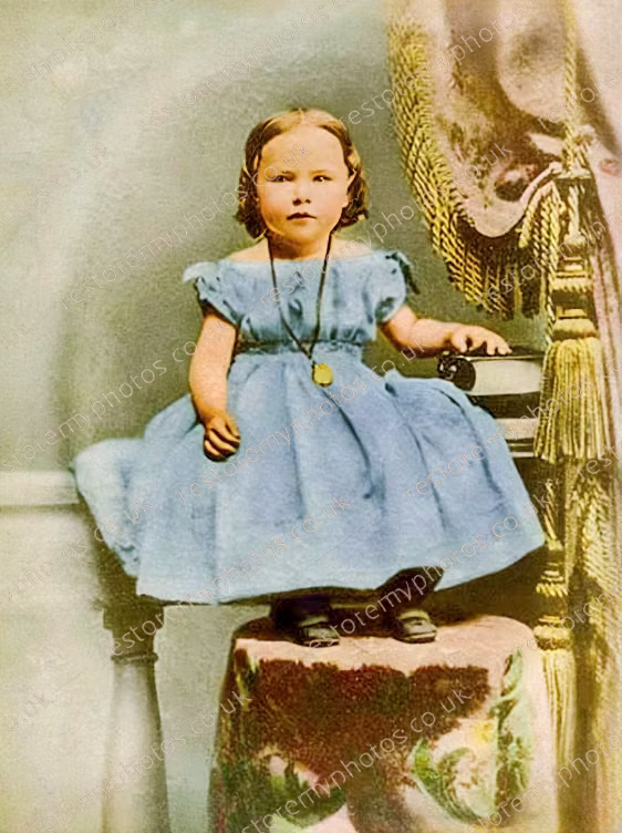 The same 1940s child portrait after the water damage was cleared